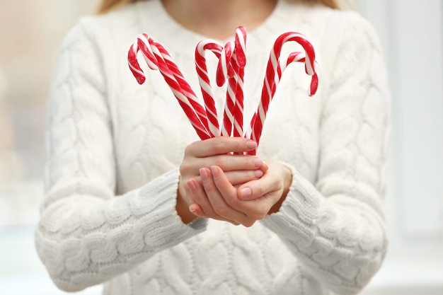 Woman holding candy canes, closeup