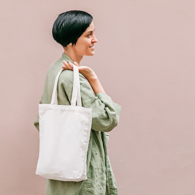 Woman holding canvas tote bag. reusable eco bag. eco friendly\
concept.