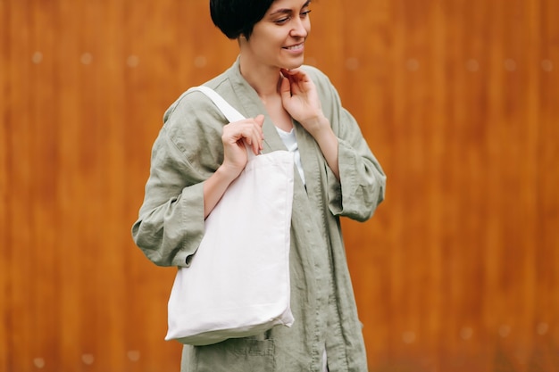 Photo woman holding canvas tote bag. reusable eco bag. eco friendly concept.