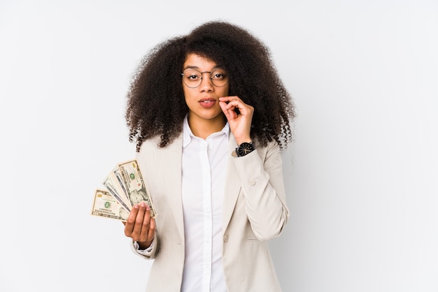 Woman holding cash in studio