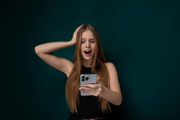 Woman holding cell phone in front of face