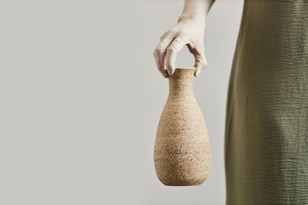 Woman holding ceramic art minimal