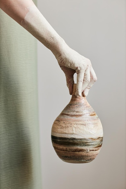 Woman holding ceramic art