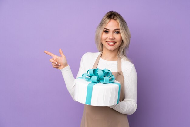 Woman holding chocolate over isolated wall