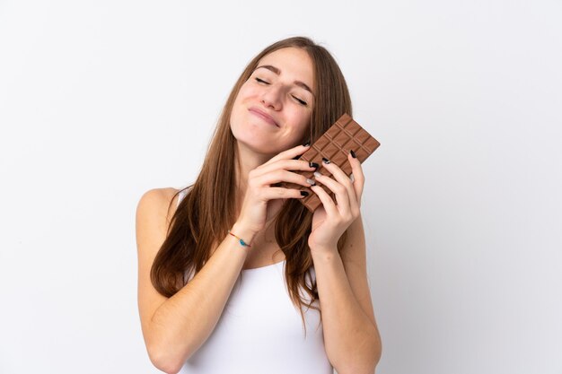 Woman holding chocolate over white wall