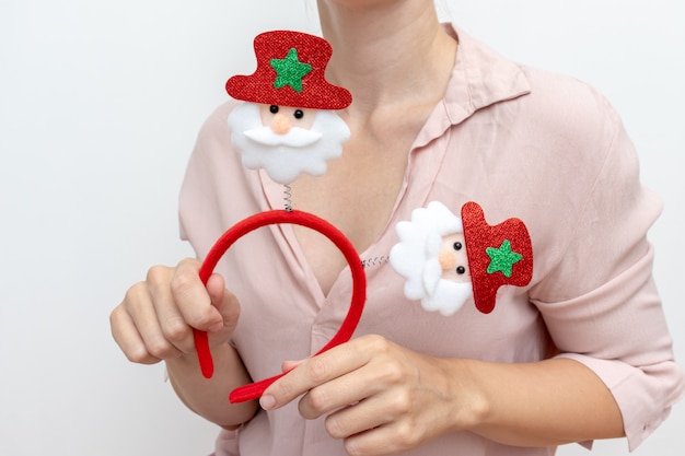 Woman holding christmas accsessory with santa clauses