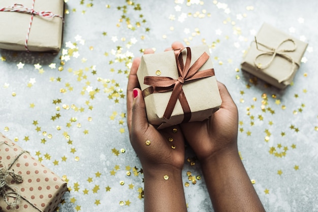 Woman holding Christmas gift in her hands