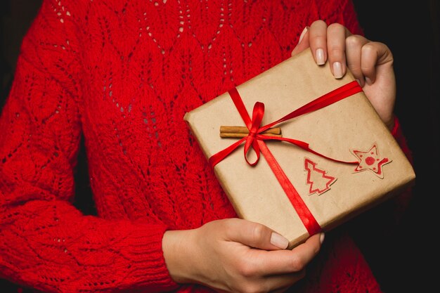 A woman holding a Christmas gift