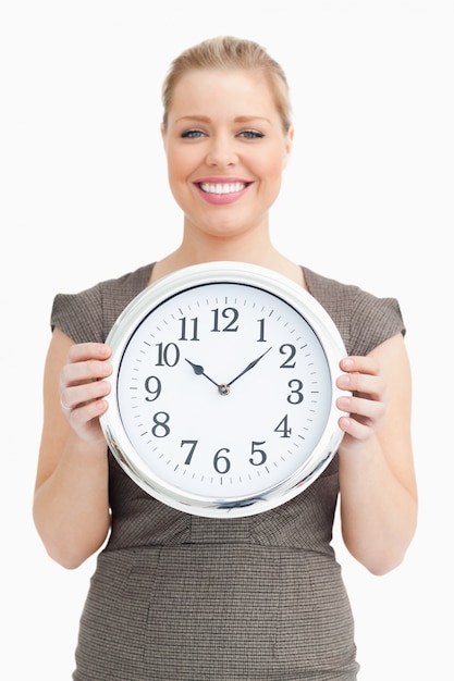 Woman holding a clock in her hands