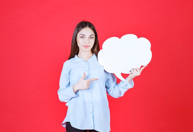 woman holding a cloud shape info board. 