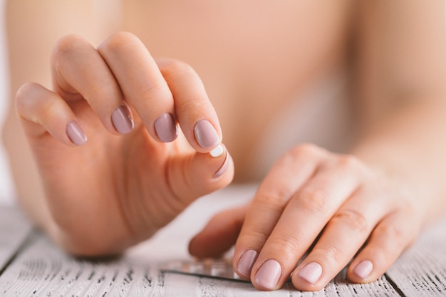 Woman holding contraceptive solutions