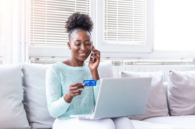 Woman holding credit card and talking on the phone