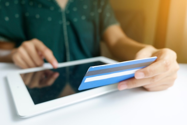 Photo woman holding  credit card with tablet .  shopping online , business online