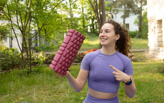 A woman holding a cube of ice cubes