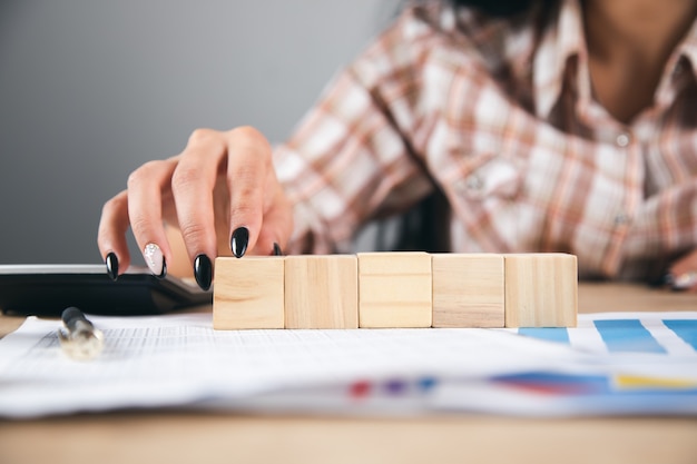 Woman holding cubes on working documents