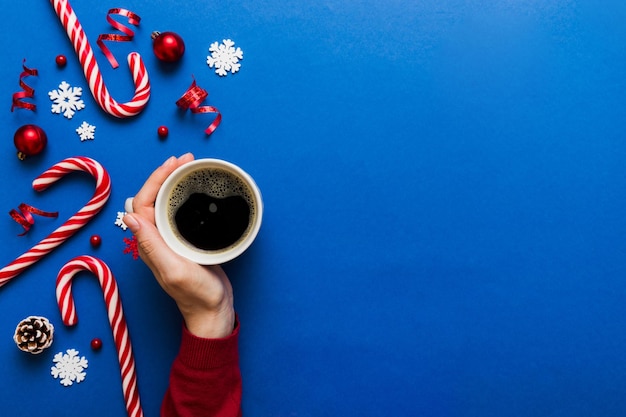 Woman holding cup of coffee Woman hands holding a mug with hot coffee Winter and Christmas time concept