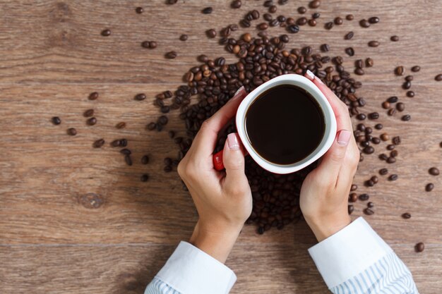 Woman holding a cup of hot coffee