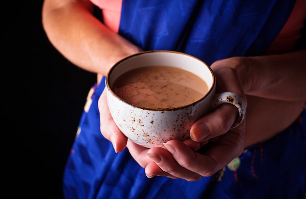 Woman  holding a cup of masala  tea