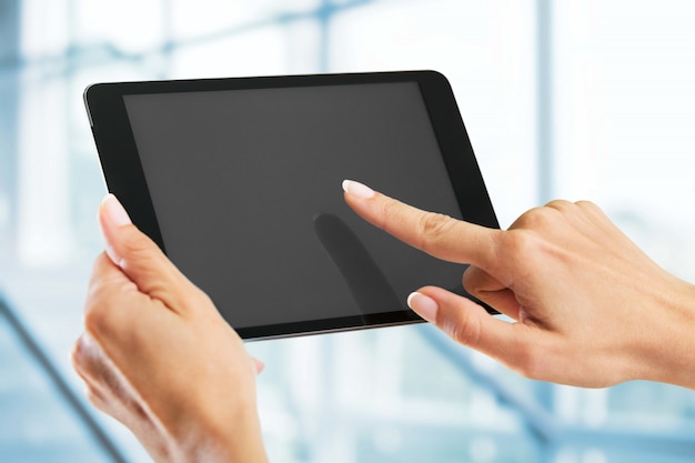 Woman holding   digital tablet on background