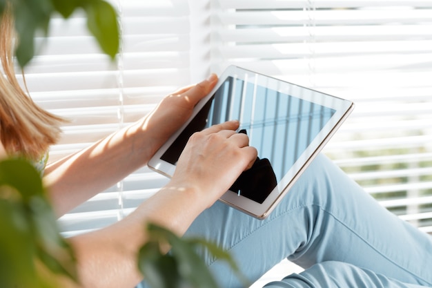 woman holding digital tablet, closeup