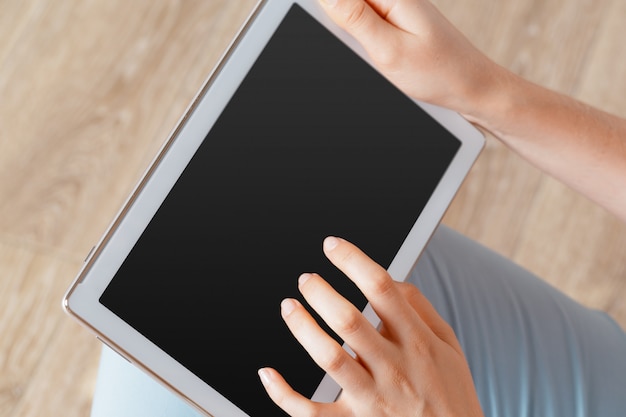 Woman holding digital tablet, closeup