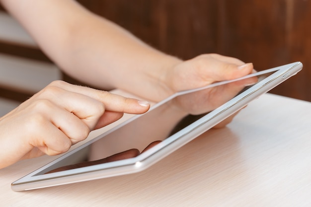 Woman holding digital tablet, closeup