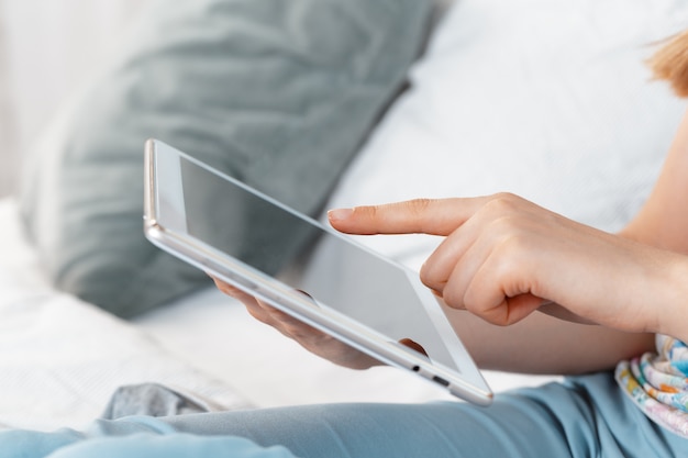 Woman holding digital tablet, closeup