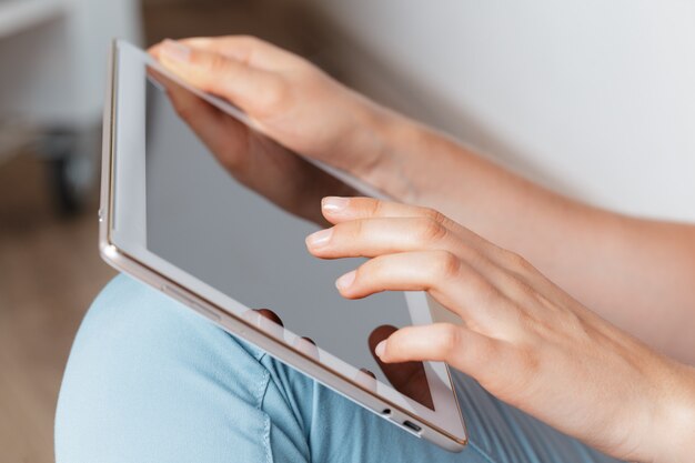 Woman holding digital tablet, closeup