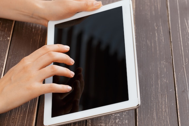 Woman holding digital tablet, closeup