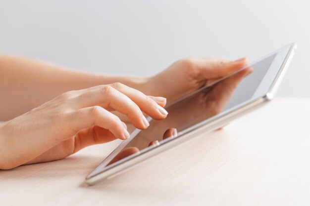 Woman holding digital tablet, closeup