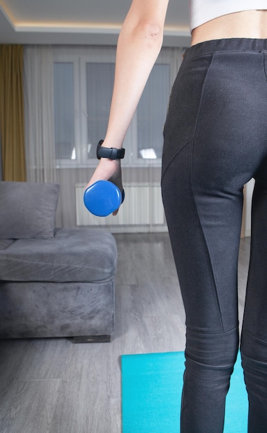 Woman holding dumbbell Exercise at home