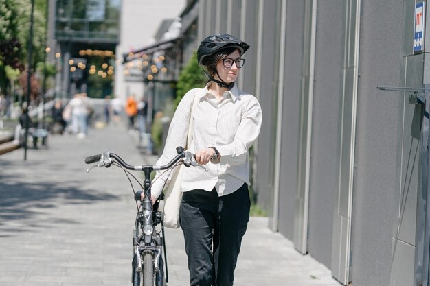woman holding eco bag or cotton tote bag in the city while riding a bike