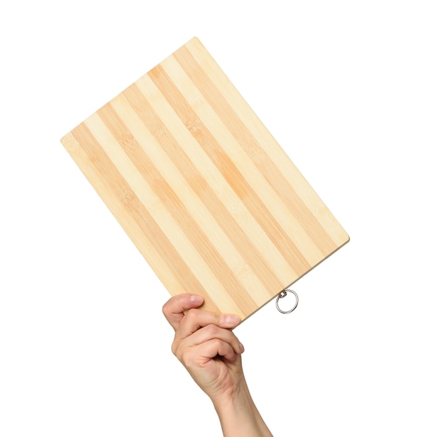 Woman holding empty brown rectangular wooden board in hand, body part on white background