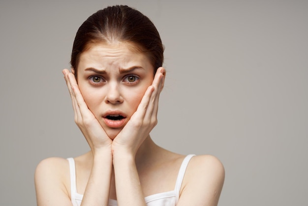 Woman holding on to face pain in teeth studio treatment