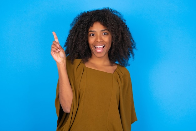 woman holding finger up having idea and posing