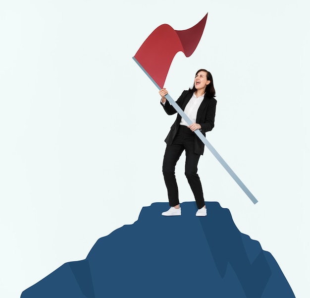 Woman holding a flag on top of a mountain