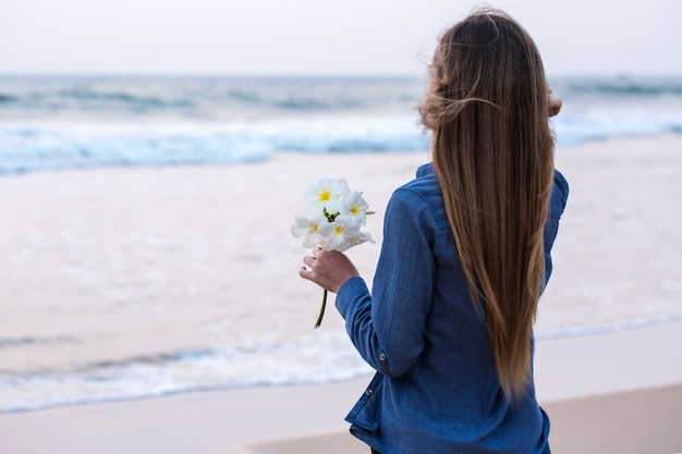 A woman holding a flower