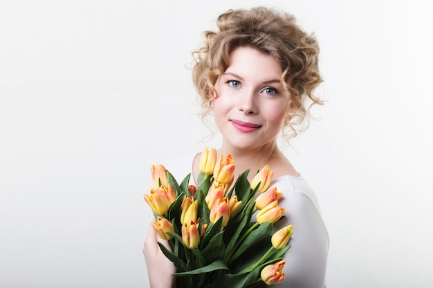 Woman holding flowers tulips.