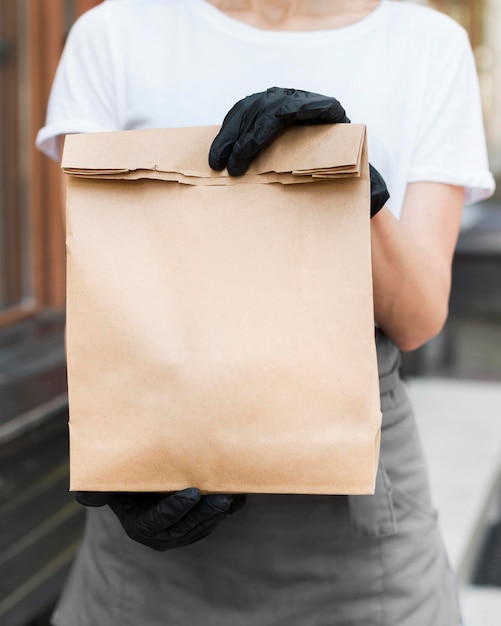 Woman holding food delivery bag