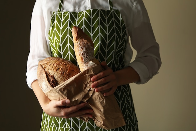 Woman holding fresh baked bread