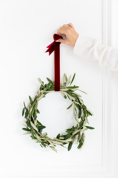 Woman holding a fresh Christmas wreath