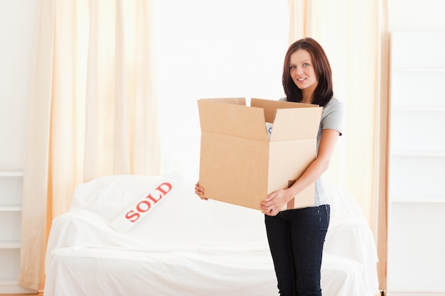 Woman holding full cardboard