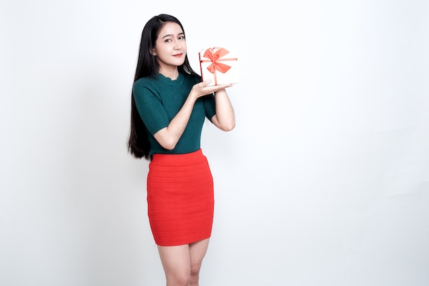 Woman holding gift box and toothy smiling