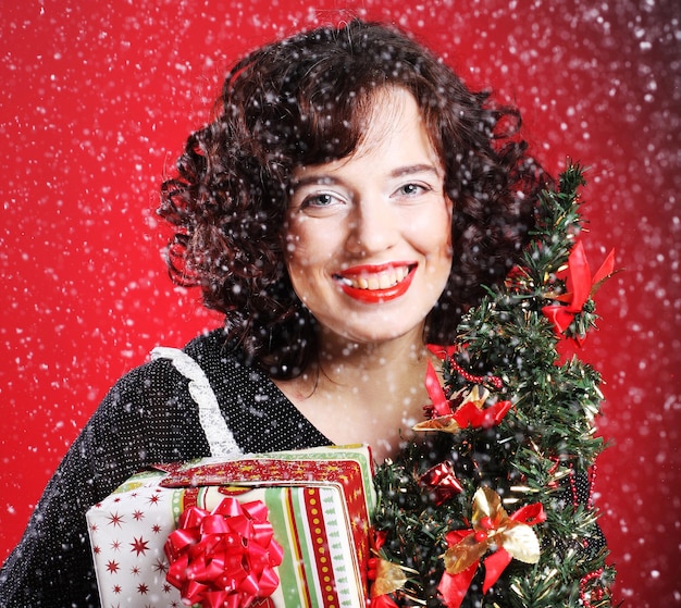 Woman holding gift and the tree