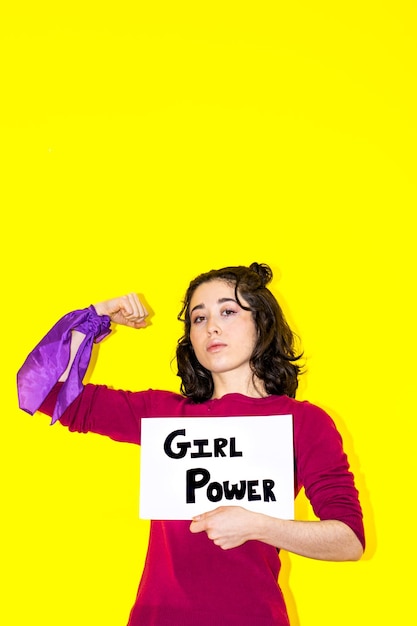 woman holding girl power sign