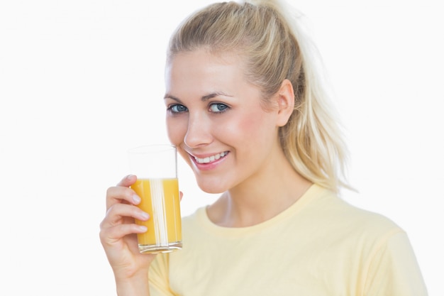 Woman holding glass of orange juice