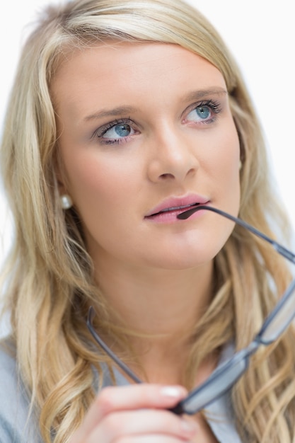 Woman holding glasses at her mouth