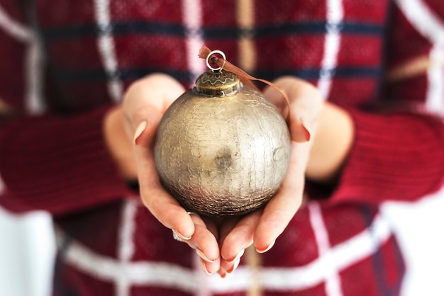 Woman holding a gold bauble