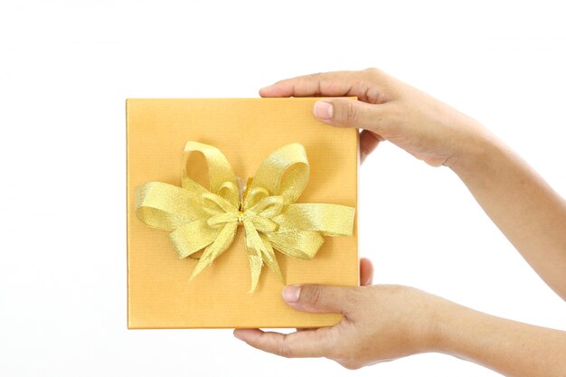 Woman holding a gold gift box