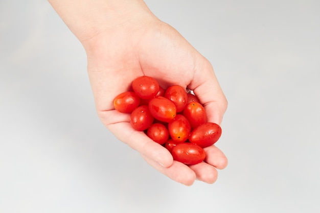 Woman holding grape tomatoes